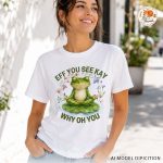Woman wearing white frog meditation graphic t-shirt outdoors