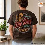 model wearing the brown have the day you deserve graphic tee